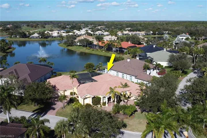 Aerial view of property's location with a nearby body of water and nearby suburban area
