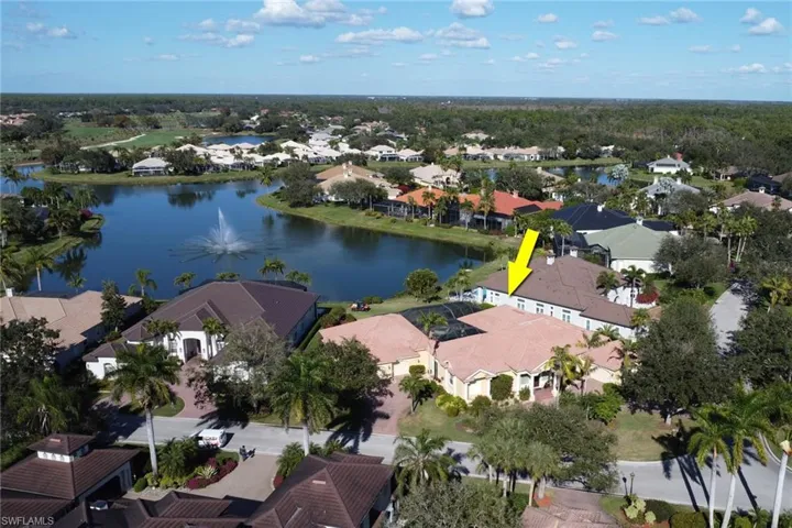 Aerial view of property's location with a nearby body of water and nearby suburban area