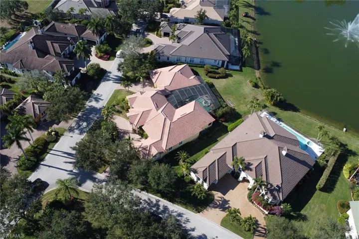 Aerial perspective of suburban area featuring a nearby body of water