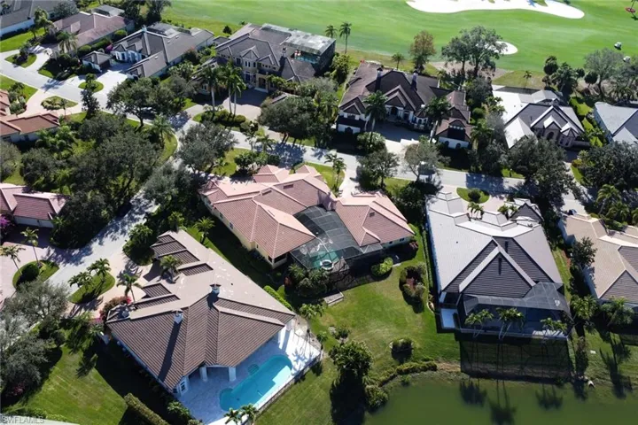 Aerial perspective of suburban area featuring a golf course