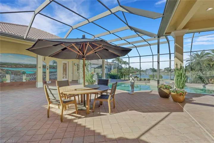 View of patio / terrace featuring glass enclosure, a sunroom, an outdoor pool, and outdoor dining space