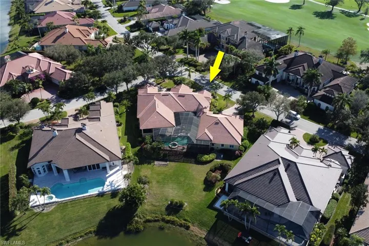 Aerial perspective of suburban area featuring a local golf course and a pool area