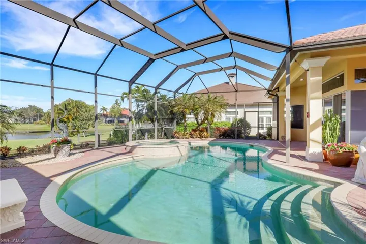 View of pool featuring a sunroom, a pool with connected hot tub, a patio, and a lanai