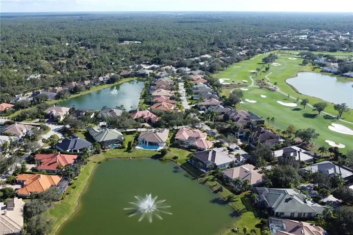 Aerial overview of property's location featuring a nearby body of water and nearby suburban area