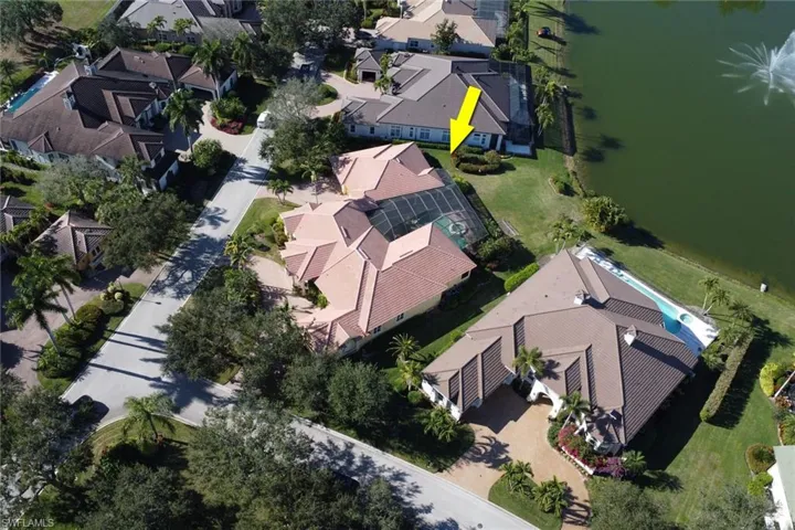 Aerial perspective of suburban area featuring a nearby body of water