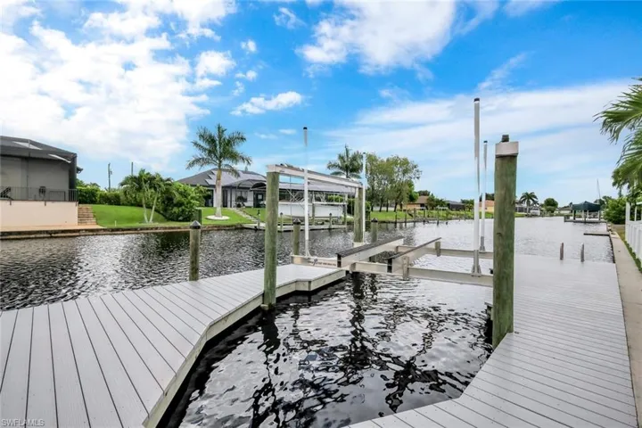 Dock area with a water view and boat lift