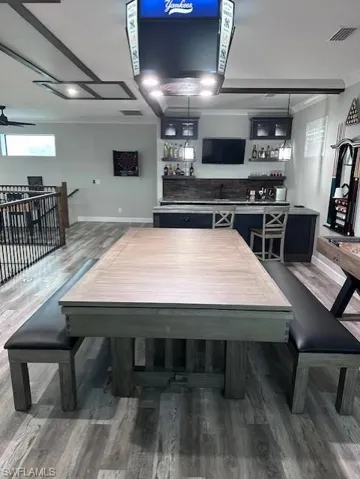 Yankee decor on light can be changed to different team. Pool table converted to dining table with bench seats