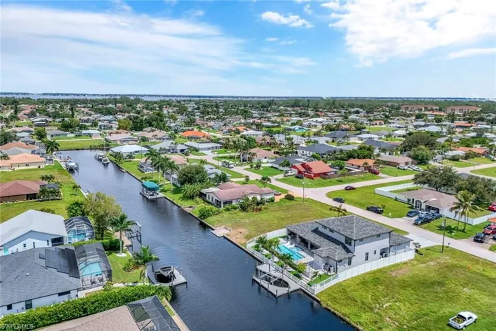 Aerial view of residential area featuring a large body of water