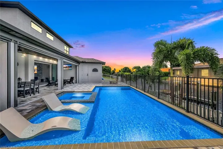 View of swimming pool with a patio and a pool with connected hot tub