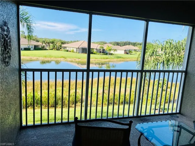 Sunroom / solarium featuring a water view
