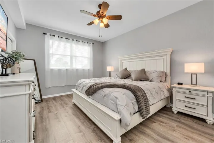 Master Bedroom featuring new LVP - light wood style flooring and a ceiling fan