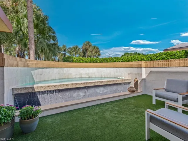 Cocktail spa with privacy wall and water feature