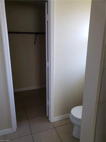 toilet alcove and door to walk in closet