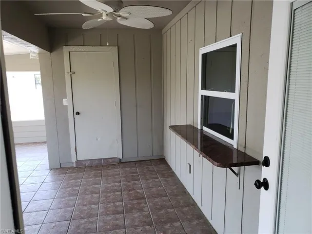 Screened lanai area to pass through counter to kitchen.  Door to extra storage area.