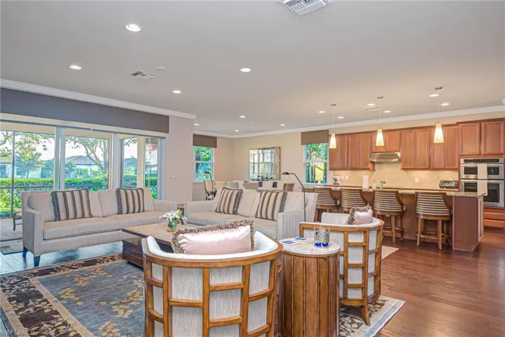 Living room with crown molding and dark hardwood / wood-style floors