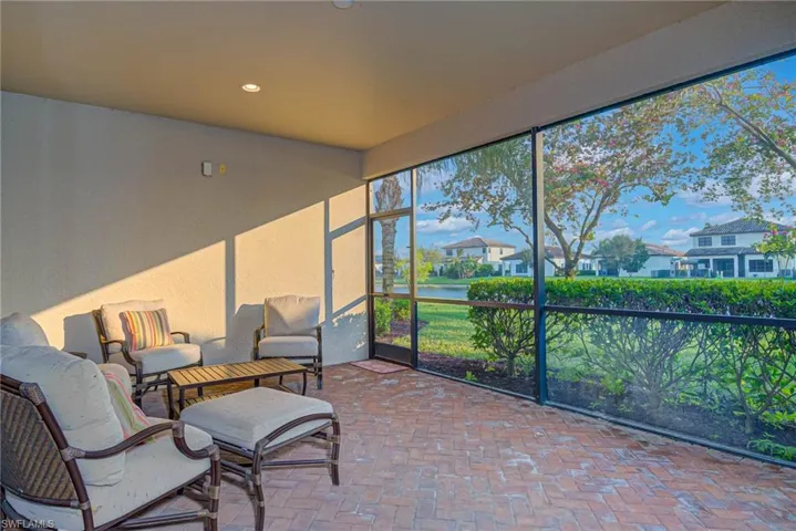 Screened porch featuring a water view