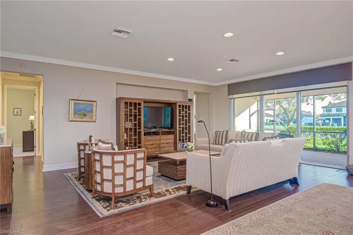 Living room featuring crown molding and dark hardwood / wood-style flooring