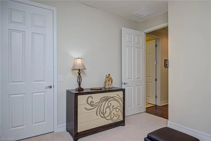 Hallway with light colored carpet
