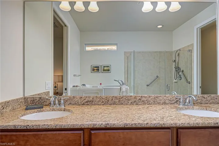 Bathroom with vanity and a shower with door