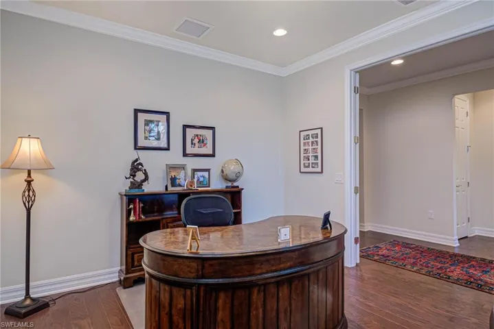 Office space featuring wood-type flooring and ornamental molding