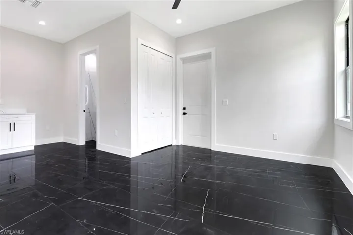 Bonus room / Media Room / Home Office featuring access door to the outside, tile floors,wet bar, ceiling fan, and recessed lighting