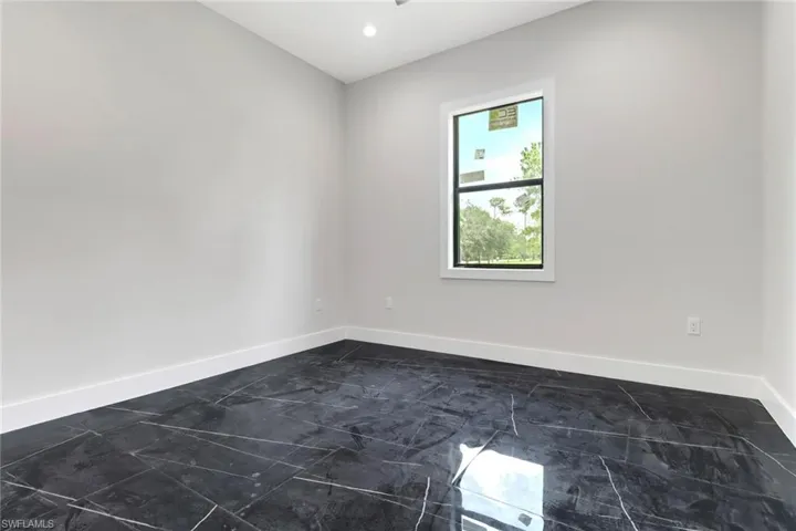 Guest bedroom with tile flooring and recessed lighting