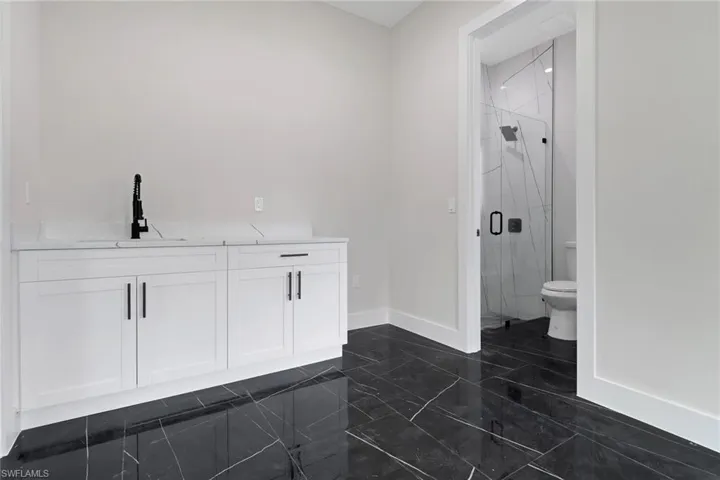 Bonus Room / Media Room / Home Office with wetbar area and access to private bathroom