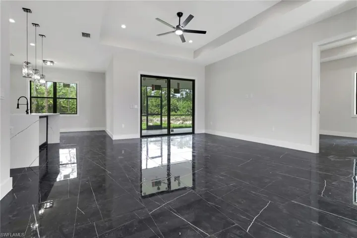 Light and bright great room with sliding doors to access the screened lanai