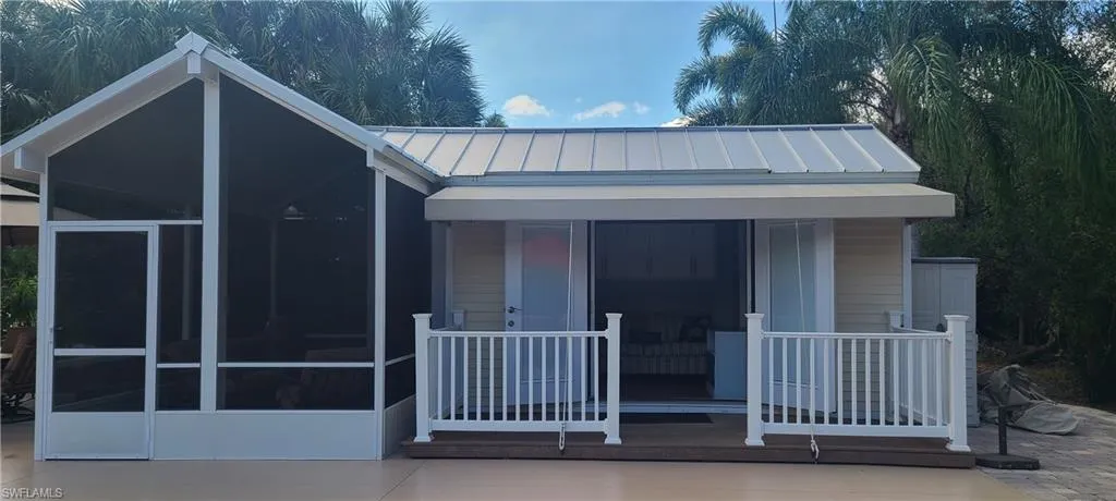 View of front of home featuring a sunroom