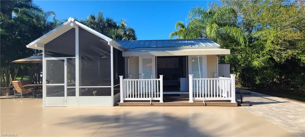 View of front facade featuring a patio area and a sunroom