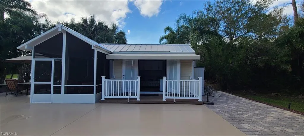 View of front of house featuring a patio and a sunroom