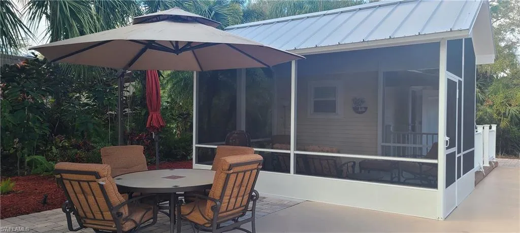 View of patio with a sunroom