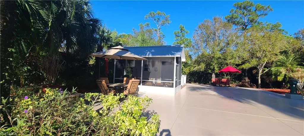 Back of house featuring a patio area and a sunroom