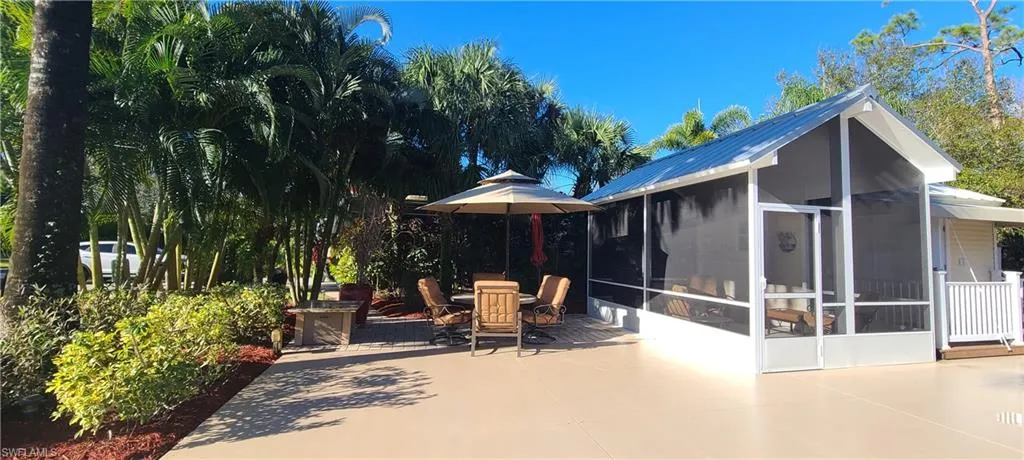 View of patio with a sunroom