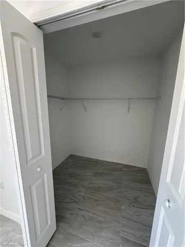 Walk in closet featuring tile floors