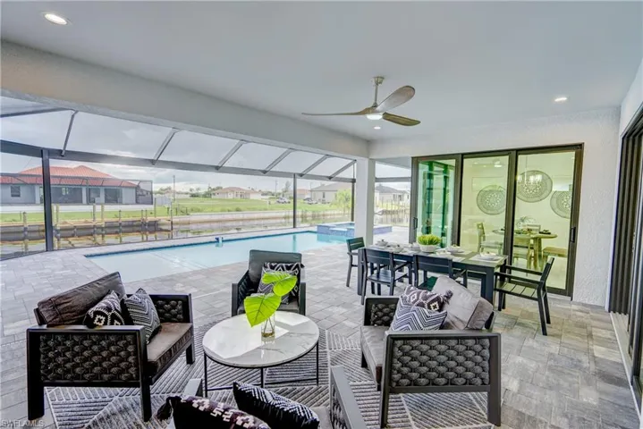 Sunroom featuring a pool and ceiling fan