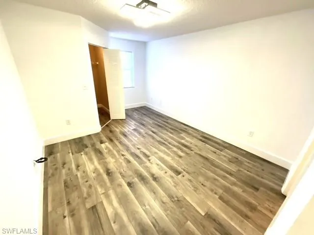 Spare room with wood-type flooring