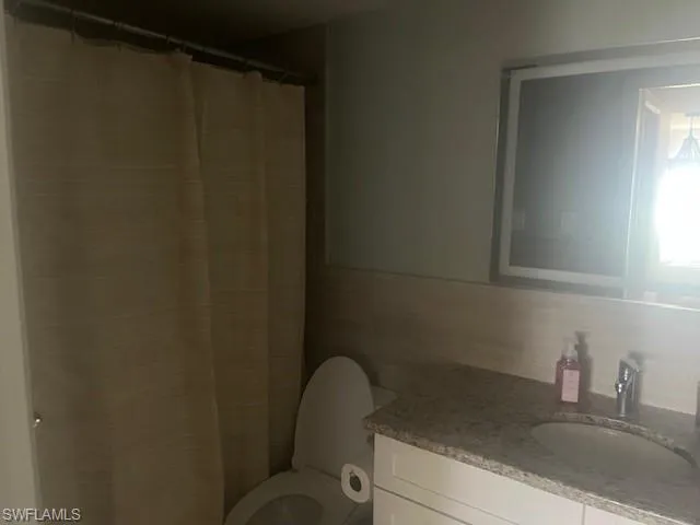 Full bath with vanity and curtained shower