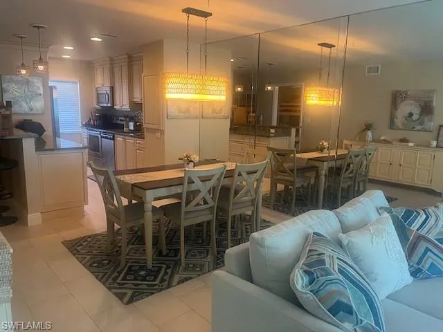 Dining space featuring light tile patterned floors and recessed lighting