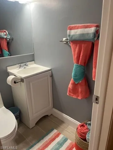 Half bath featuring wood finish floors and vanity