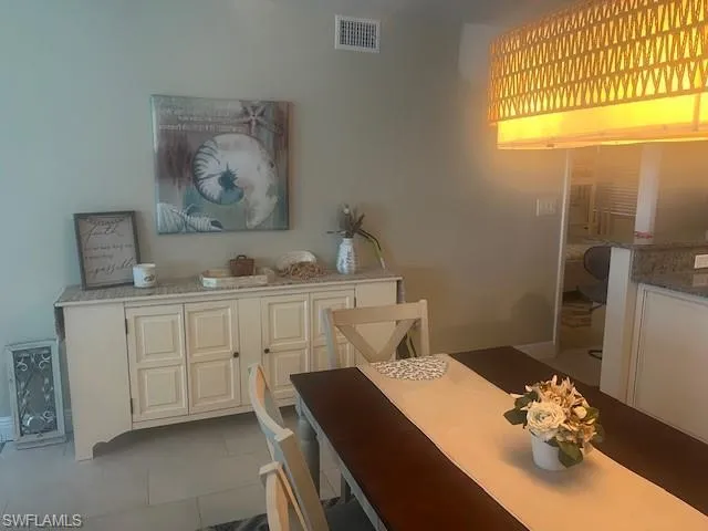 Dining space with dark tile patterned floors