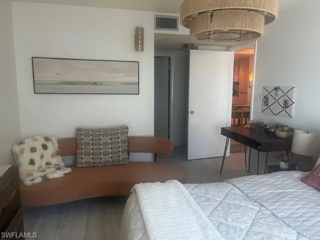 Bedroom featuring wood finished floors and ensuite bathroom