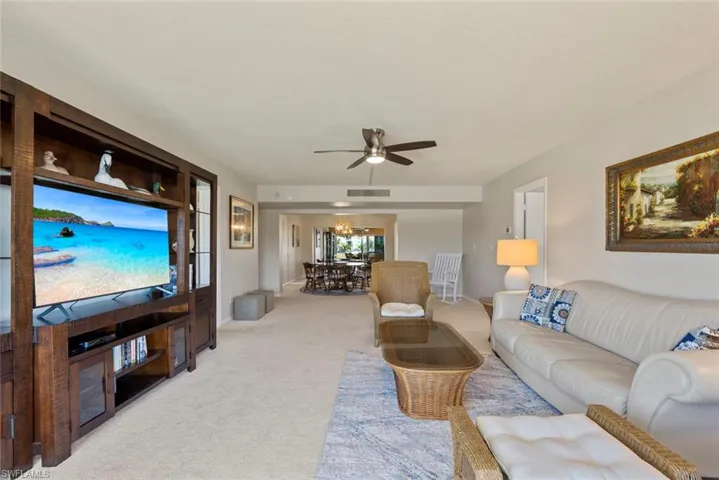 Living area featuring carpet floors and ceiling fan