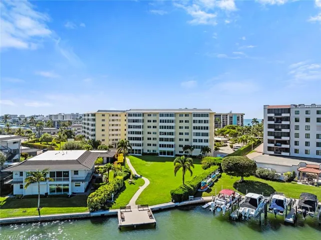 Bird's eye view of a nearby body of water and apartment complex / building