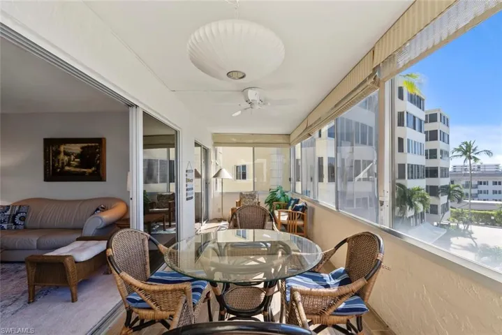 Sunroom / solarium featuring a ceiling fan and outdoor dining area