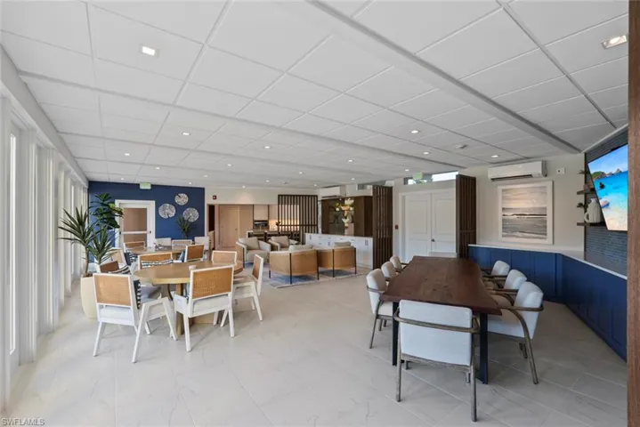 Dining room with a paneled ceiling, recessed lighting, an AC wall unit, and a wall unit AC