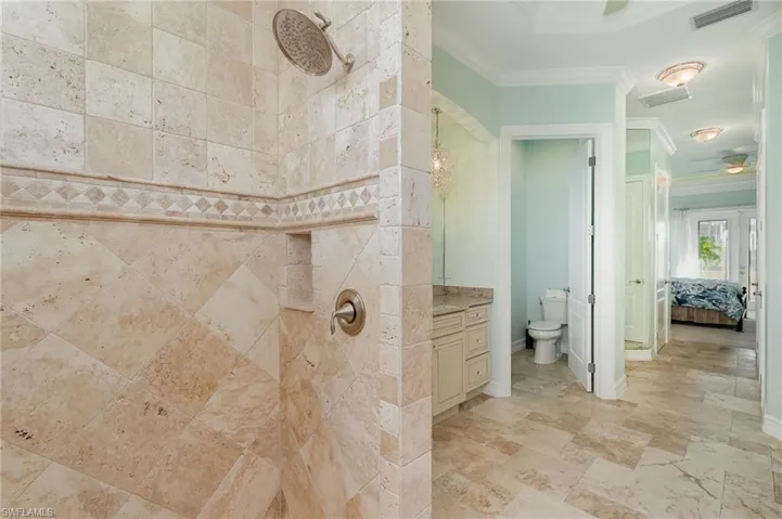 Master bathroom with tumbled marble tile shower, and unique finshes