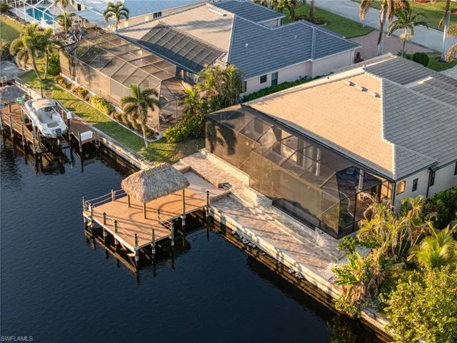 Birds eye view of property with a water view