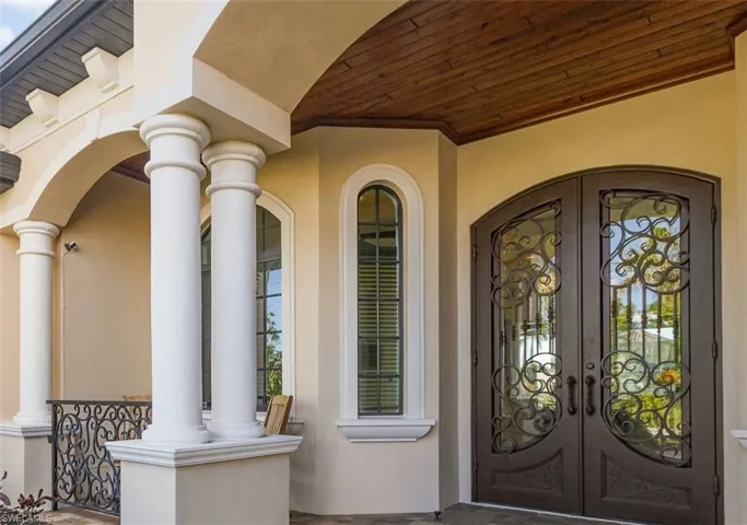 Front Porch displaying iron railing, iron french doors and wood plank ceiling