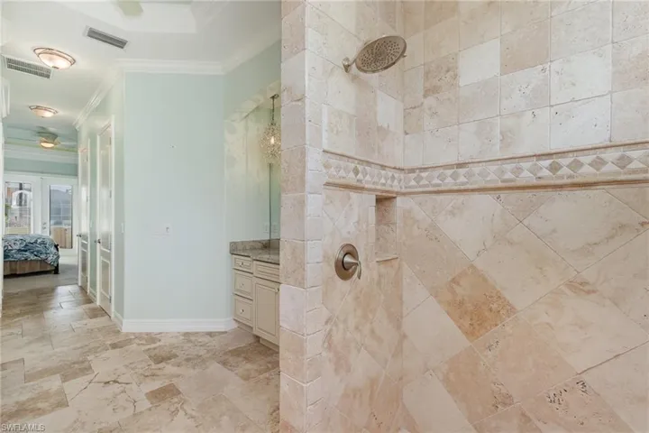 Master bathroom with tumbled marble tile shower, and unique finshes